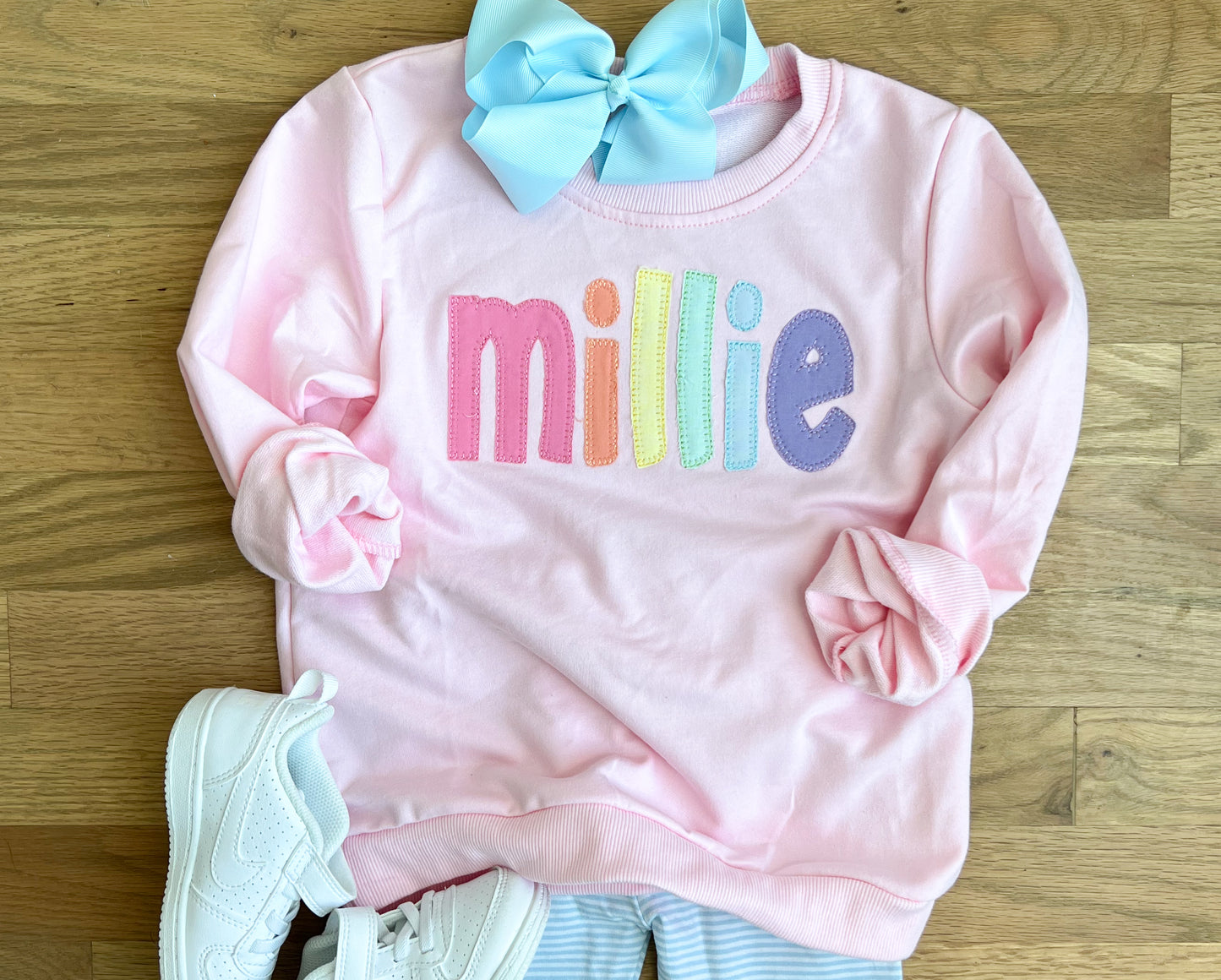 Pink rainbow appliqué name sweatshirt