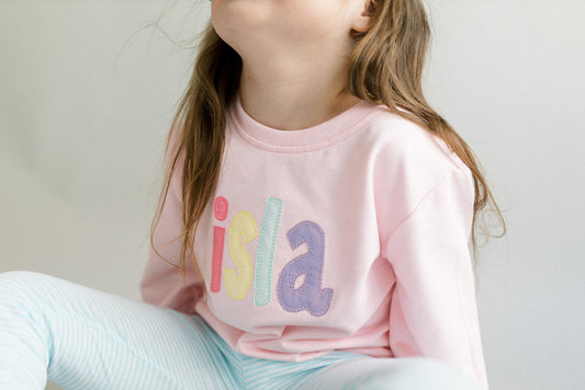 Pink rainbow appliqué name sweatshirt